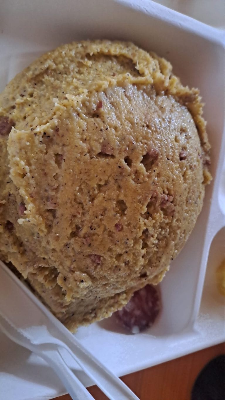 Un piatto di polenta carbonera servita con salame